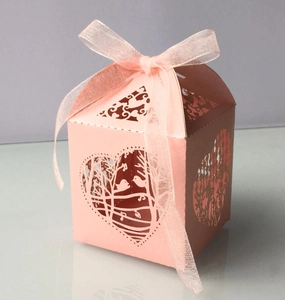 Pink laser-cut candy box with love birds heart pattern and satin ribbon bow