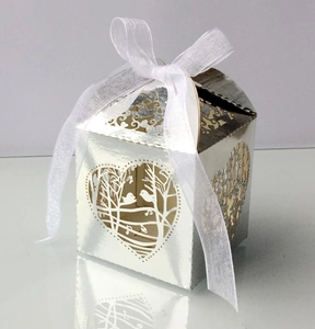 Laser-cut silver wedding favor box with romantic bird heart pattern and white ribbon bow