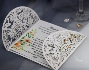 Elegant laser-cut floral wedding invitation card set with watercolor printed insert leaf
