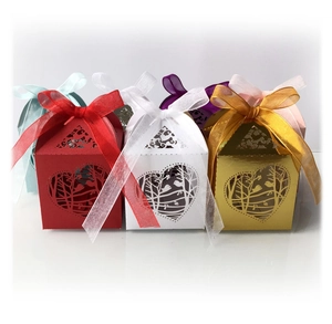 Laser-cut wedding candy boxes with bird and heart patterns in multiple colors