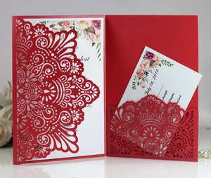Detail showing red laser-cut wedding invitation sleeve with floral insert and RSVP card