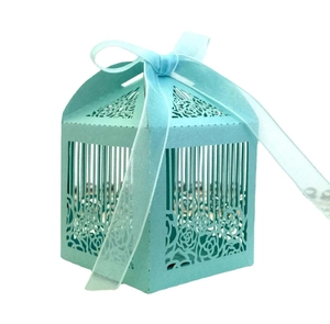 European laser-cut wedding candy box in light blue with ribbon and floral patterns