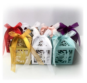 Laser cut hollow wedding candy boxes in various colors with Love design and silk ribbons