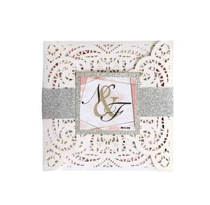 Elegant laser cut white floral wedding invitation with silver glitter belt and marble card