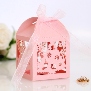 Pink laser cut Christmas candy box with tree and snowflake patterns and ribbon bow
