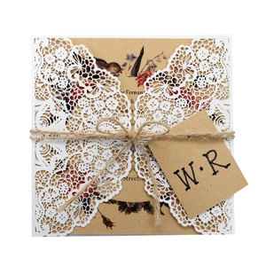 Elegant laser cut wedding invitation with white lace sleeve and rustic jute twine tie