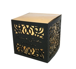 Detailed laser-cut pattern on a custom black gift box with gold interior lining