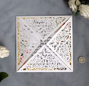 Close-up of laser-cut rose hollow invitation with elegant pearlescent paper texture