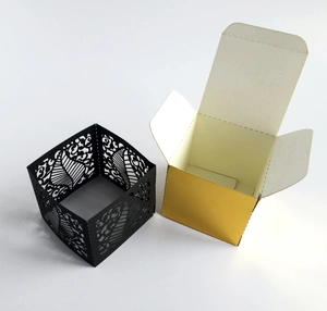 Elegant black laser-cut lace wedding favor box with gold insert for candy and gifts