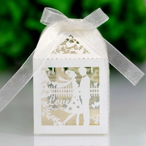 Laser cut white wedding candy box featuring bride and groom silhouette with a white ribbon