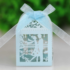 Light blue laser-cut wedding favor box with love heart motif and satin ribbon bow