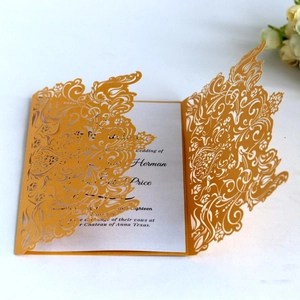 Elegant gold laser cut lace wedding invitation with floral pattern and white insert card