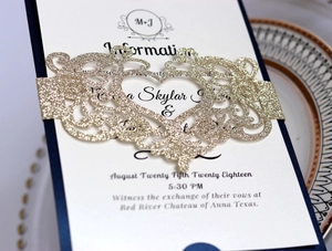 European navy blue wedding invitation with laser-cut gold glitter belly band and pearl paper