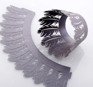 Detailed laser-cut silver cupcake wrappers featuring intricate wing and feather pattern