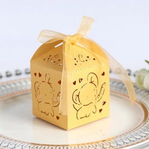 Laser-cut yellow gift box with cartoon elephant pattern and golden ribbon bow