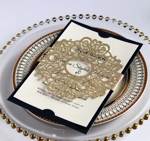 Detail of laser-cut gold glitter belly band on a navy blue pearlescent wedding invitation