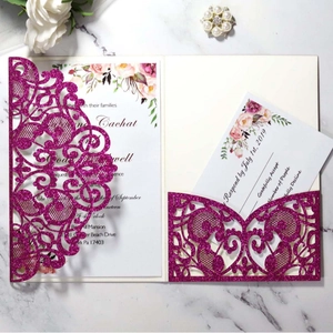 Elegant laser-cut purple glitter wedding invitation set with floral card on marble surface