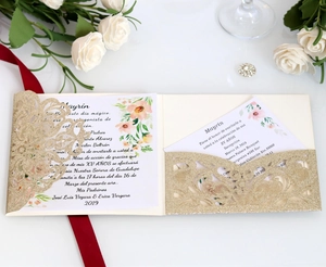 Detail view of laser-cut glitter gold invitation card with floral insert for XV Años