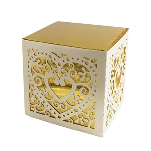 Elegant laser cut cream and gold wedding candy box with hollow heart pattern