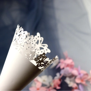 White laser-cut butterfly wedding paper cones for petal tossing or party favors