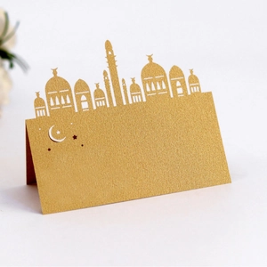 Golden laser cut mosque seat card with crescent moon and stars for Ramadan table setting