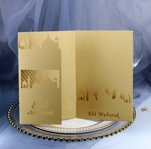 Laser-cut gold Eid Mubarak card featuring mosque silhouette on a decorative plate
