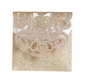 Detailed laser-cut hollow pattern on champagne gold glitter wedding invitation card