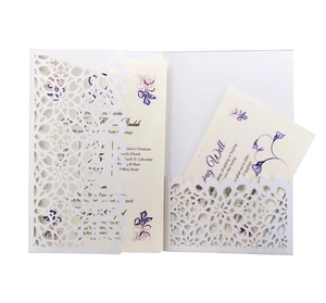 Detailed laser-cut wedding invitation set with white floral pattern and purple insert