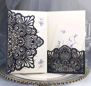 Detail of navy blue laser-cut glitter wedding invitation with mandala pattern and floral card