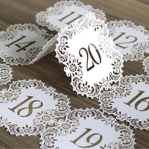 Elegant white laser-cut hollow lace table number cards for wedding banquet decor