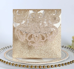 Elegant rose gold glitter laser cut wedding invitation with intricate scroll pattern