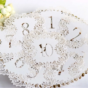 Elegant white laser-cut lace wedding table cards with numbers 1-20 for seat placement