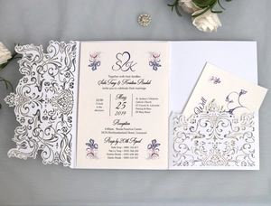 Macro detail of laser-cut floral wedding invitation with elegant purple flower printing