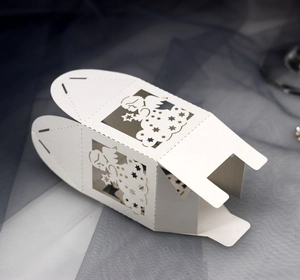 Detailed laser cut white angel candy box with intricate star patterns and pearl paper texture