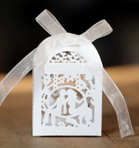 Elegant white laser-cut wedding favor box with romantic couple design and ribbon bow