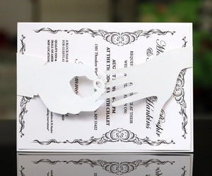Laser cut wedding invitation belly band with hands holding ring design on white paper