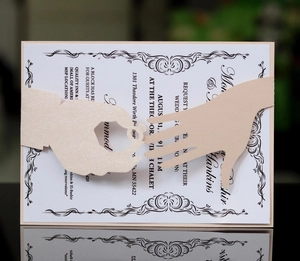 Detail of laser-cut pearl pink wedding invitation band featuring a ring exchange design
