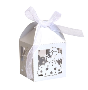 Detail of laser-cut angel gift box with white satin ribbon bow for wedding favors
