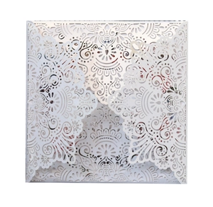 Detail of laser-cut floral lace pattern on square white wedding invitation cover