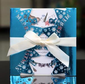 Laser cut Merry Christmas greeting card in metallic blue with snowflake deer motifs