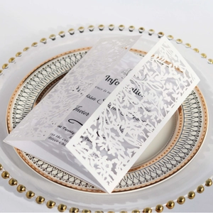 Elegant white laser-cut floral invitation card with refined paper vine patterns