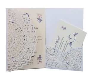 Detail of laser-cut wedding invitation set with elegant floral patterns and text