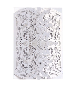Elegant white laser-cut wedding invitation featuring intricate floral lace patterns