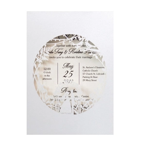 Laser-cut white wedding invitation set with floral patterns and printed inner card
