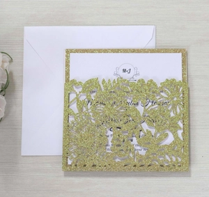 Laser cut floral wedding invitation with gold glitter pocket, inner card, and white envelope