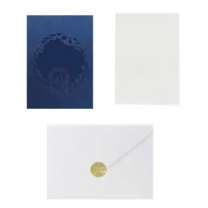 Navy blue laser-cut floral wedding invitation set with white inner card and gold wax seal