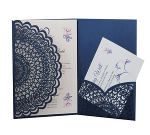 Elegant navy blue laser-cut wedding invitation with intricate mandala lace design and cards
