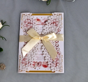 Elegant laser-cut wedding invitation set with champagne bow and rose floral insert