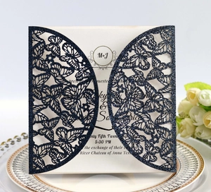 Detailed laser-cut navy blue glitter wedding invitation with elegant butterfly pattern