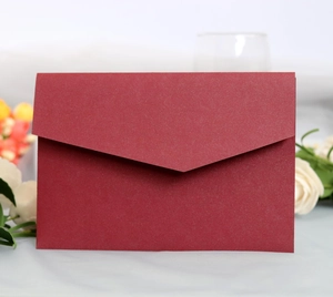 Elegant dark red V-flap wedding invitation envelope with floral decorative background